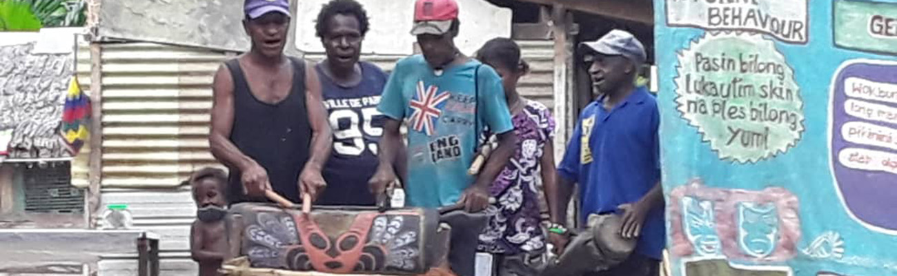 Villagers playing out washing hands as part of the Covid Education Project